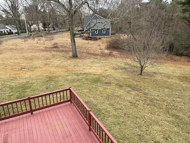 wooden terrace featuring a lawn