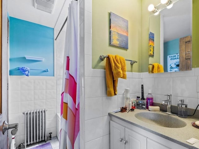 19 Tufts St, Somerville, MA 02145 - full bathroom featuring radiator heating unit, tile walls, vanity, and a shower with shower curtain