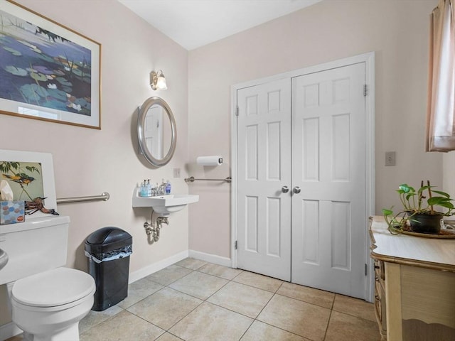 19 Tufts St, Somerville, MA 02145 - bathroom with tile patterned flooring, toilet, and baseboards
