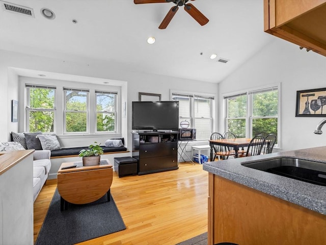 19 Tufts St, Somerville, MA 02145 - living area featuring light wood-type flooring, a ceiling fan, recessed lighting, and high vaulted ceiling