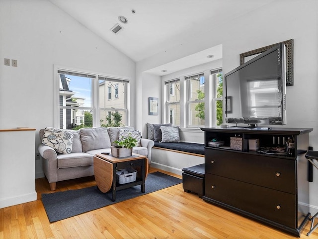 19 Tufts St, Somerville, MA 02145 - living area featuring light wood finished floors, plenty of natural light, baseboards, and high vaulted ceiling