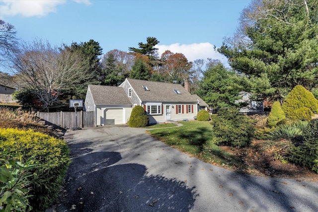 cape cod house featuring a garage