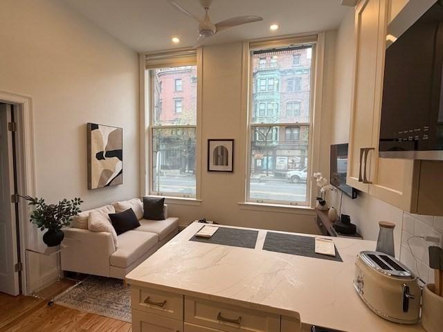 interior space with recessed lighting, ceiling fan, and wood finished floors