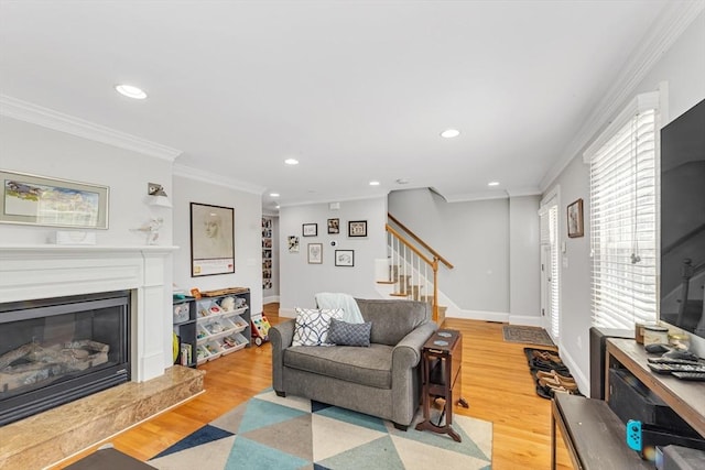 living area featuring stairway, recessed lighting, light wood-type flooring, crown molding, and baseboards