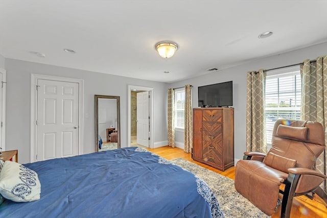 bedroom featuring light wood-style floors and baseboards