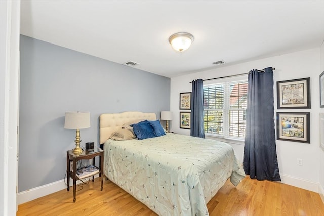 bedroom featuring light wood-style flooring and baseboards
