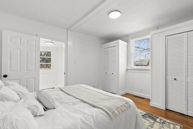 63 Adams St, Bourne, MA 02532 - bedroom with multiple closets, multiple windows, wood finished floors, and visible vents