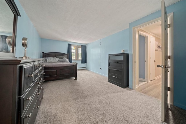 bedroom featuring a baseboard radiator, light carpet, a textured ceiling, and baseboards