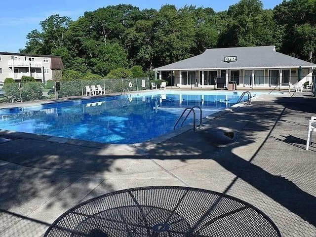 pool featuring a patio and fence