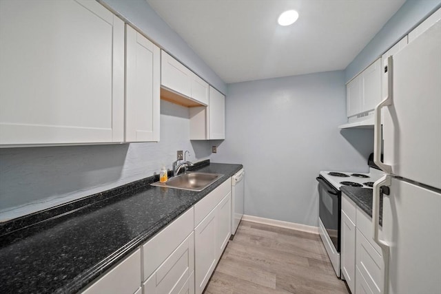 kitchen featuring under cabinet range hood, white appliances, white cabinets, and a sink