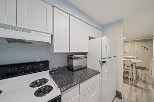 kitchen with under cabinet range hood, dark stone countertops, white cabinetry, white appliances, and light wood-style floors