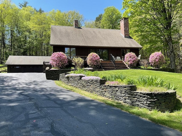 24 Conway Rd, Buckland, MA 01370 - view of front of home featuring a chimney, a front yard, a deck, and board and batten siding