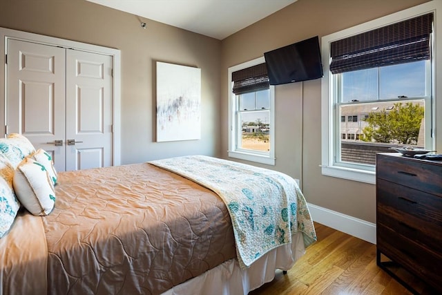 bedroom featuring light hardwood / wood-style floors and a closet