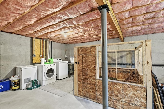 unfinished basement with washer and clothes dryer and refrigerator