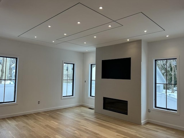 unfurnished living room with light hardwood / wood-style flooring