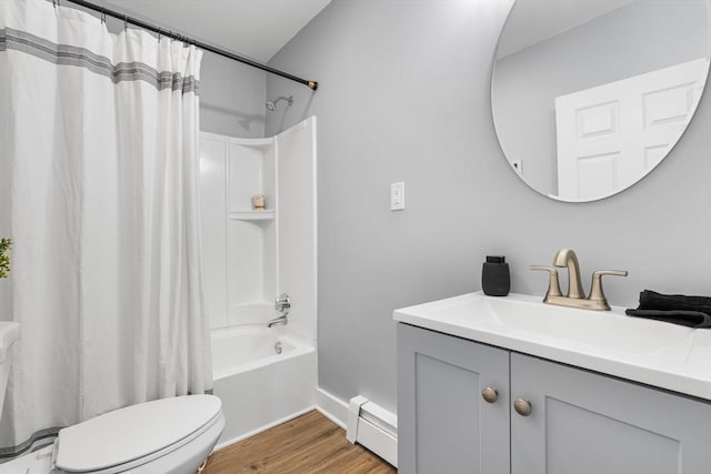 bathroom featuring baseboard heating, toilet, wood finished floors, shower / bath combo, and vanity