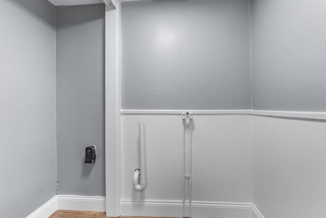laundry room with baseboards