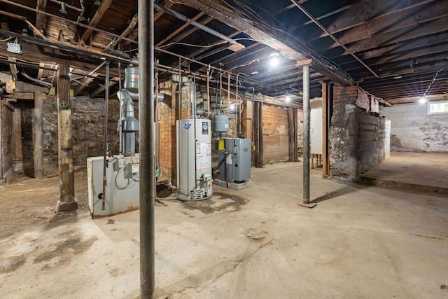 basement featuring gas water heater and a heating unit