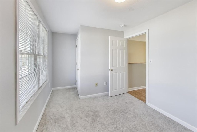 unfurnished bedroom with light colored carpet