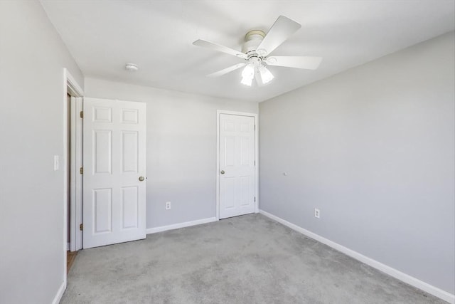 unfurnished bedroom with light colored carpet and ceiling fan