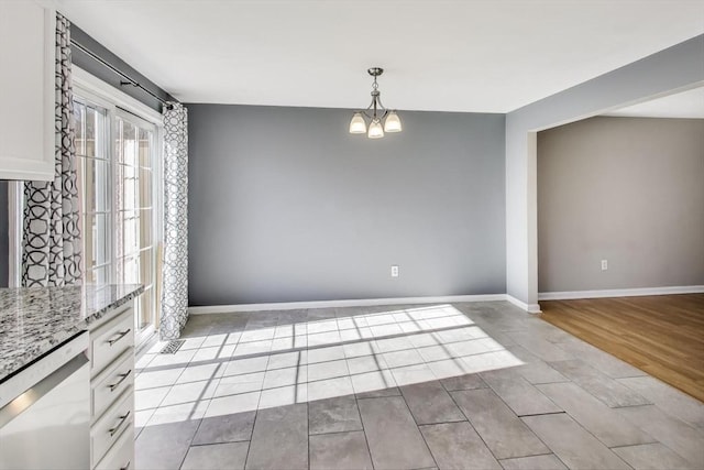 unfurnished dining area featuring light hardwood / wood-style flooring and a notable chandelier