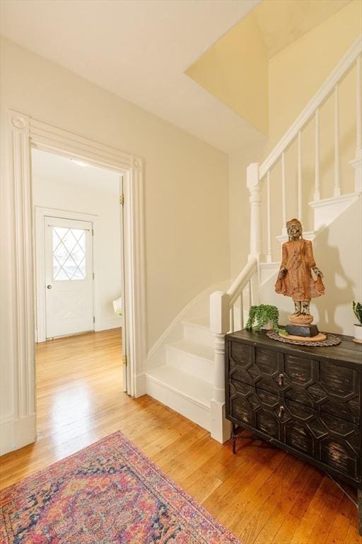 corridor with hardwood / wood-style flooring