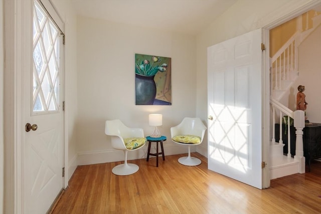 living area with vaulted ceiling and hardwood / wood-style flooring