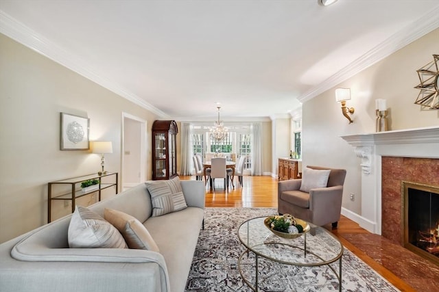 20 Hillery Rd, Leominster, MA 01453 - living room with a chandelier, wood finished floors, crown molding, a premium fireplace, and baseboards