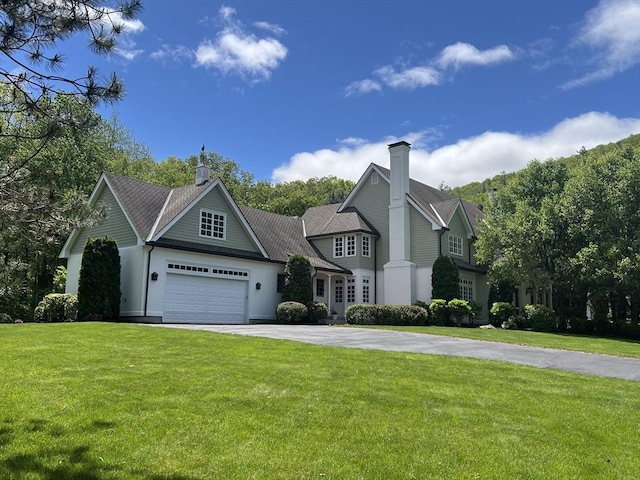 20 Hillery Rd, Leominster, MA 01453 - view of front of home with asphalt driveway, a chimney, a garage, and a front lawn