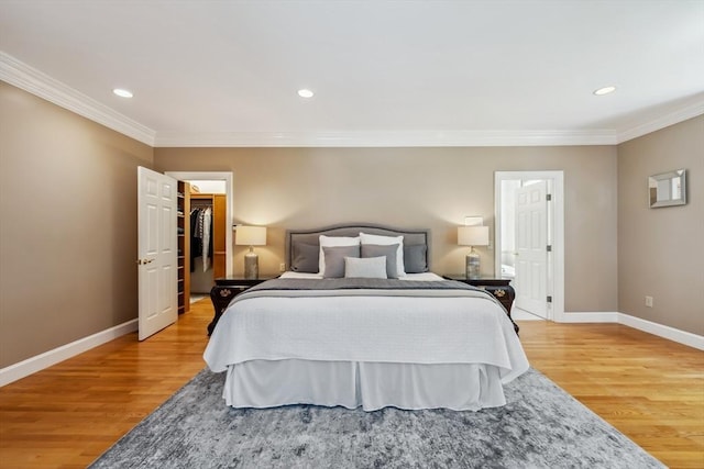20 Hillery Rd, Leominster, MA 01453 - bedroom with light wood-style floors, baseboards, crown molding, recessed lighting, and a walk in closet