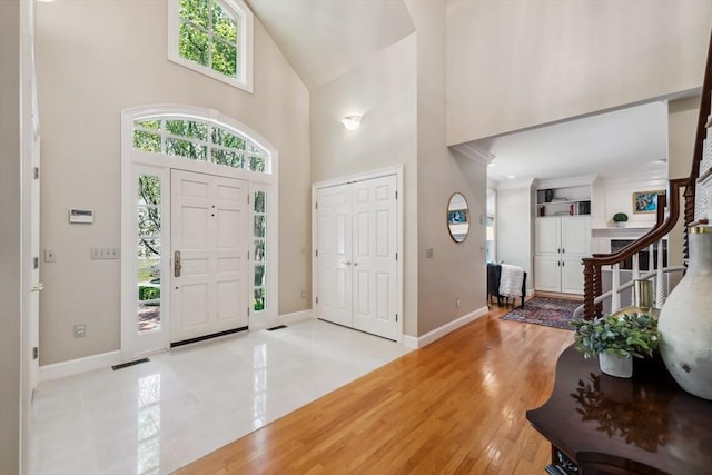 20 Hillery Rd, Leominster, MA 01453 - entryway featuring high vaulted ceiling, baseboards, plenty of natural light, and light wood-type flooring