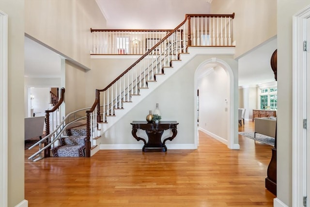 20 Hillery Rd, Leominster, MA 01453 - staircase with a towering ceiling, wood finished floors, arched walkways, ornamental molding, and baseboards