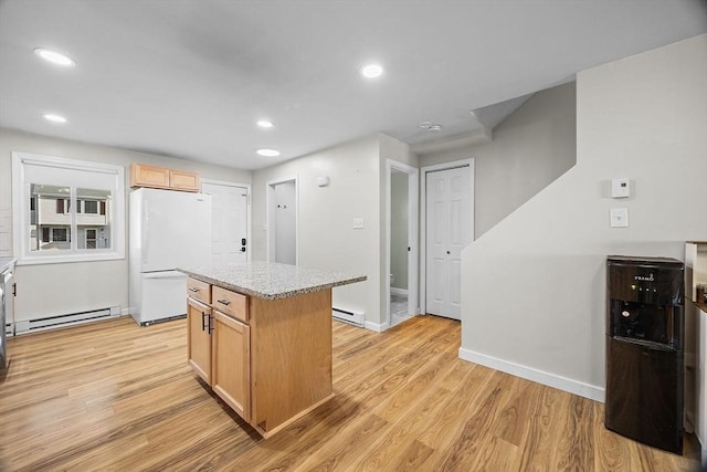 kitchen with freestanding refrigerator, light wood-style floors, and a baseboard radiator