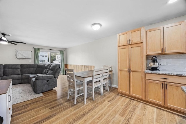 dining space featuring light wood-style flooring and a ceiling fan