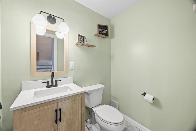 bathroom with visible vents, toilet, marble finish floor, baseboards, and vanity