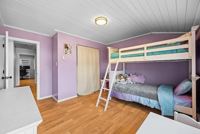 bedroom with light wood-type flooring, a closet, baseboards, wood ceiling, and vaulted ceiling