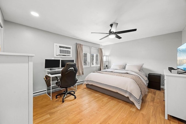 bedroom featuring light wood-style floors, ceiling fan, and a wall unit AC