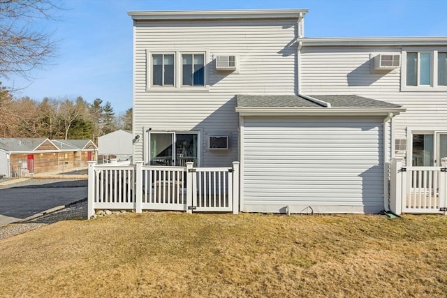 rear view of property featuring a lawn