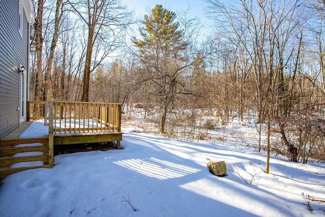 yard layered in snow featuring a wooden deck