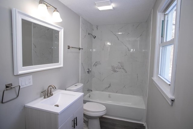 full bathroom with a textured ceiling, bathing tub / shower combination, vanity, and toilet