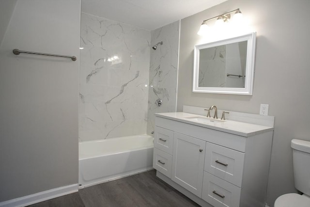 full bathroom with toilet,  shower combination, wood finished floors, and vanity