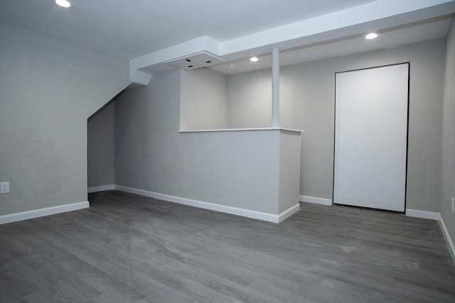 additional living space featuring baseboards, wood finished floors, and recessed lighting