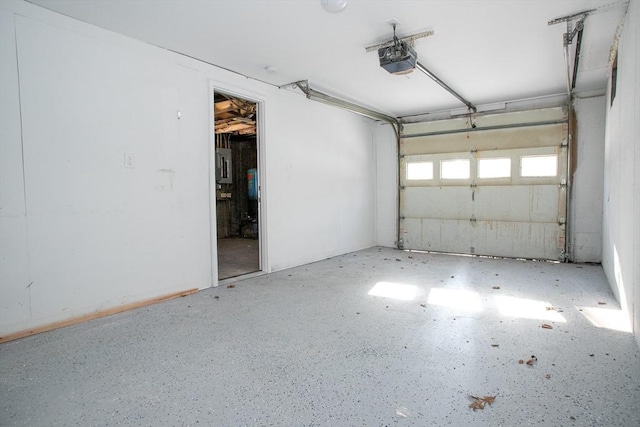 garage with a garage door opener and electric panel