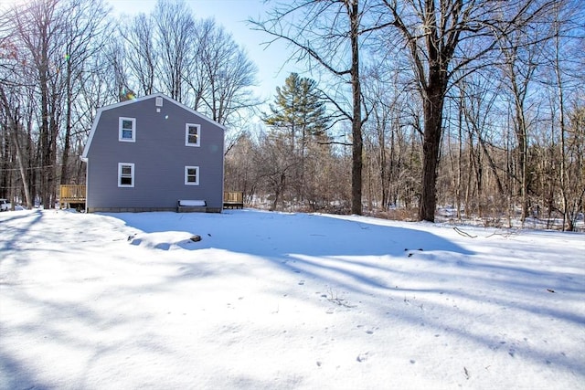 yard covered in snow featuring a deck