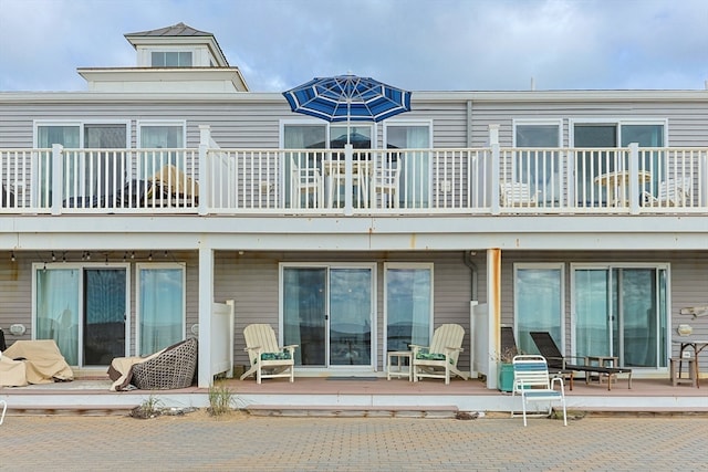 back of property with a balcony