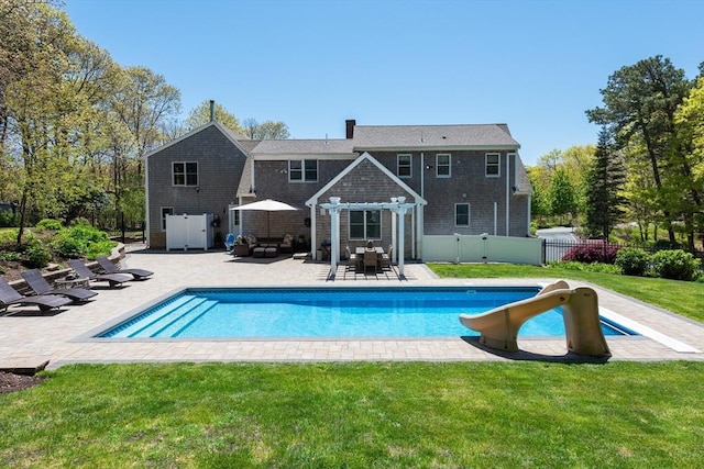 view of pool with a yard, a pergola, a patio area, and a water slide