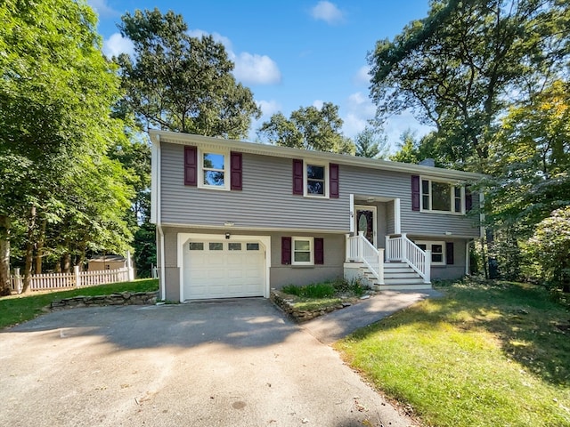 bi-level home with a front yard and a garage