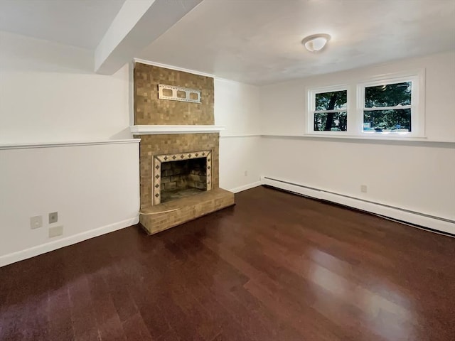 unfurnished living room with a brick fireplace, a baseboard radiator, baseboards, and wood finished floors