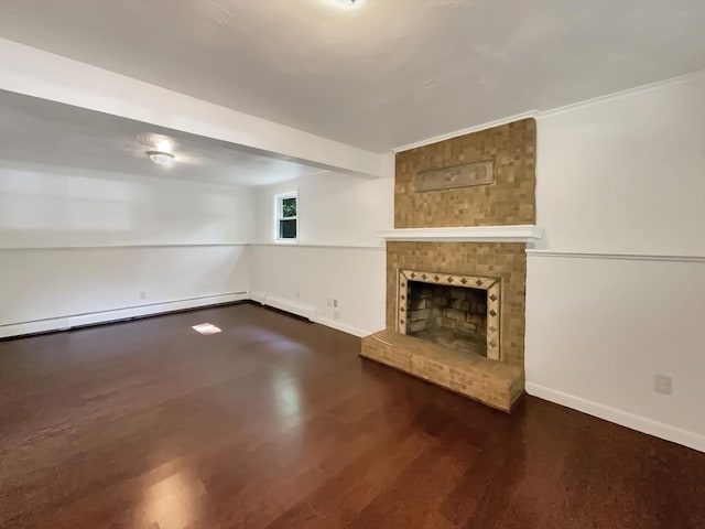 unfurnished living room featuring a baseboard heating unit, a brick fireplace, baseboards, and wood finished floors