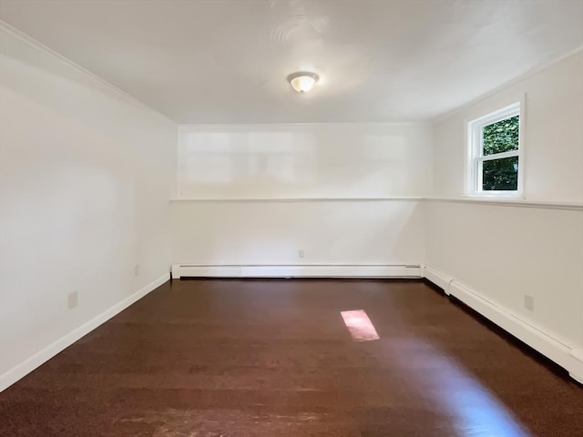 spare room with dark wood-type flooring, baseboards, and baseboard heating